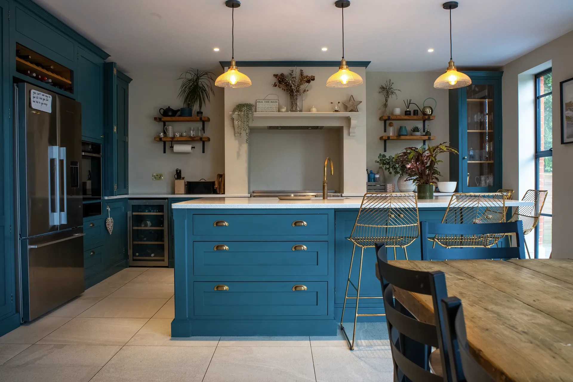 Deep blue fitted kitchen photographed for a property marketing campaign