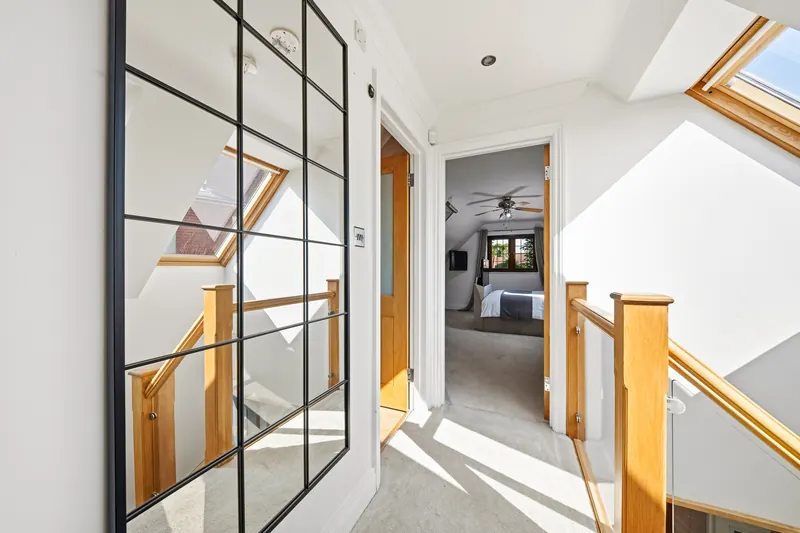 Bright upstairs hallway with glass-panel door