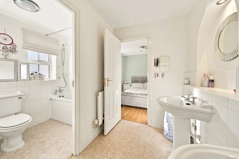 Bathroom with sinks and adjoining room