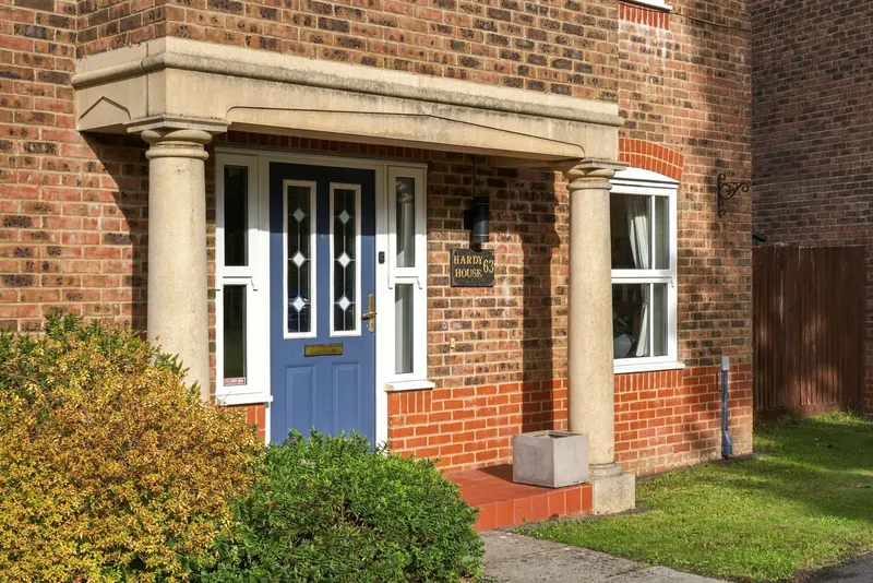 Blue front door and brick entrance at Hardy House
