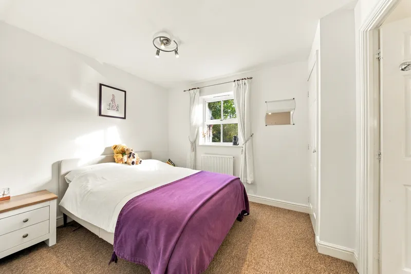 Guest bedroom with a purple throw