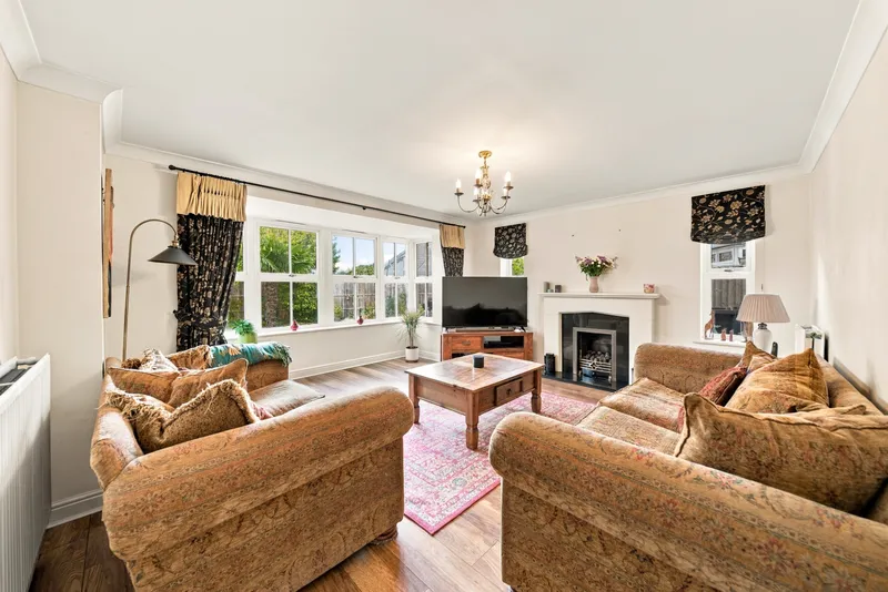 Main lounge with bay window, fireplace and seating