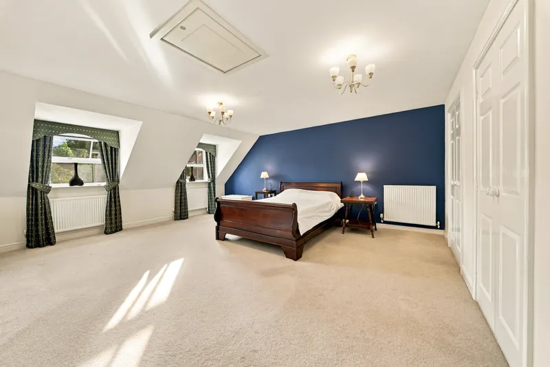 Main bedroom with deep blue feature wall