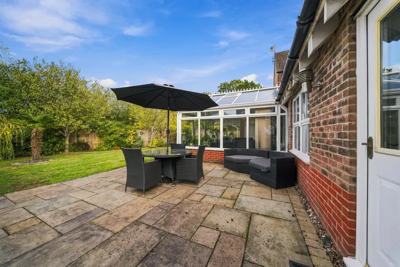 Patio seating area beside the house