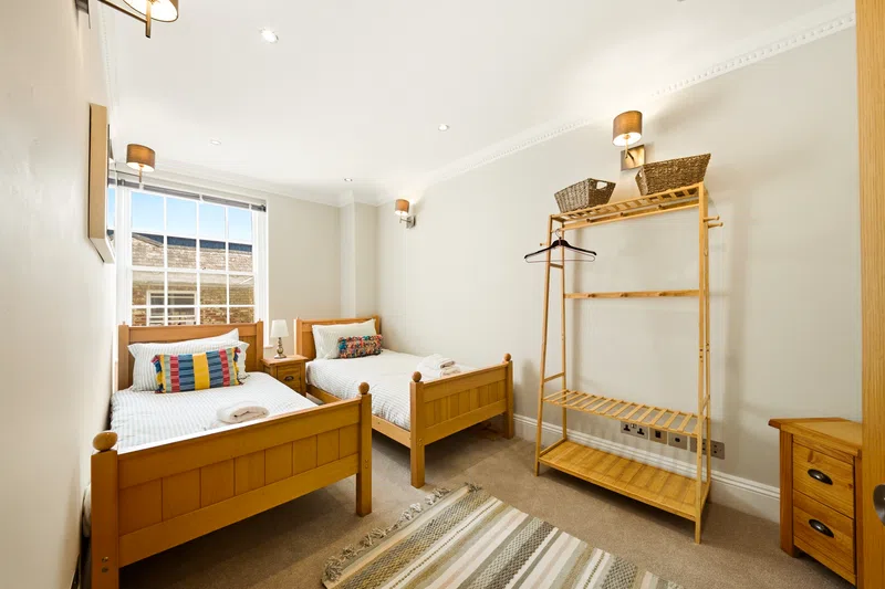 Southampton twin bedroom with wooden beds photographed for accommodation listing