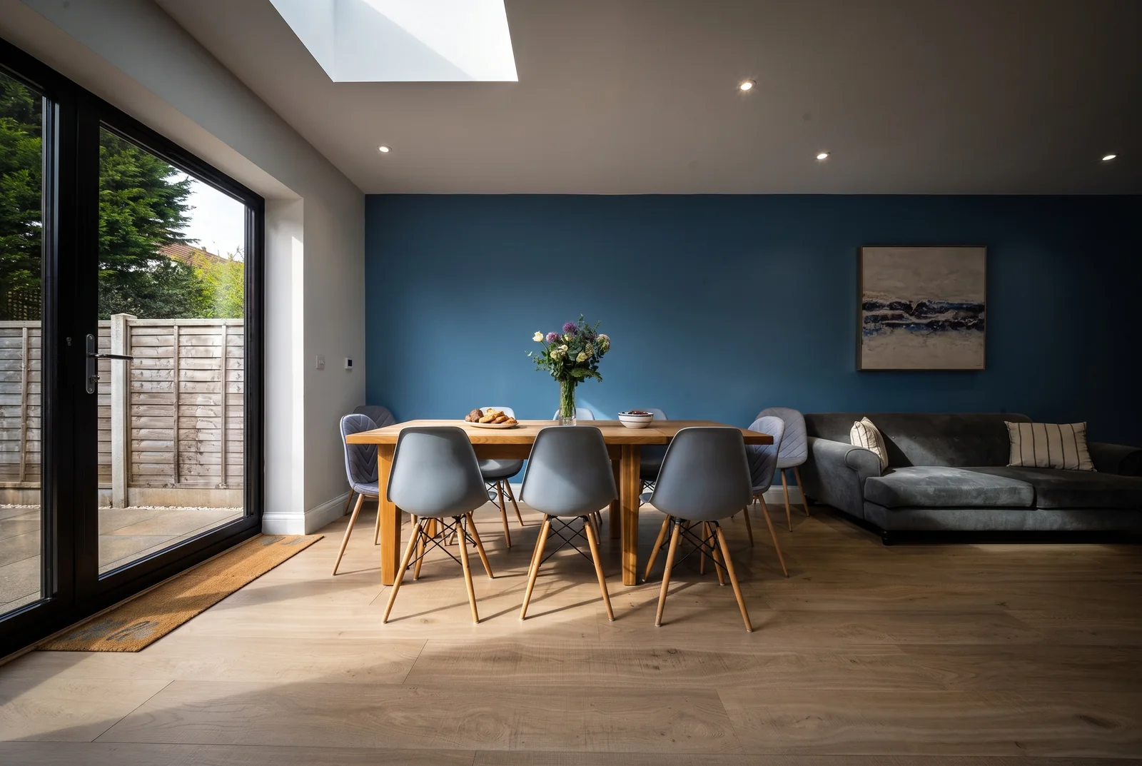 Stylised blue dining and living space photographed for an Airbnb listing
