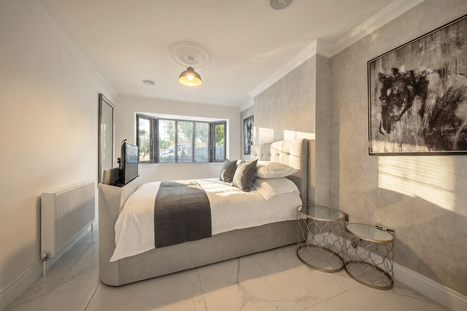 Stylised grey bedroom prepared for a holiday-let photoshoot