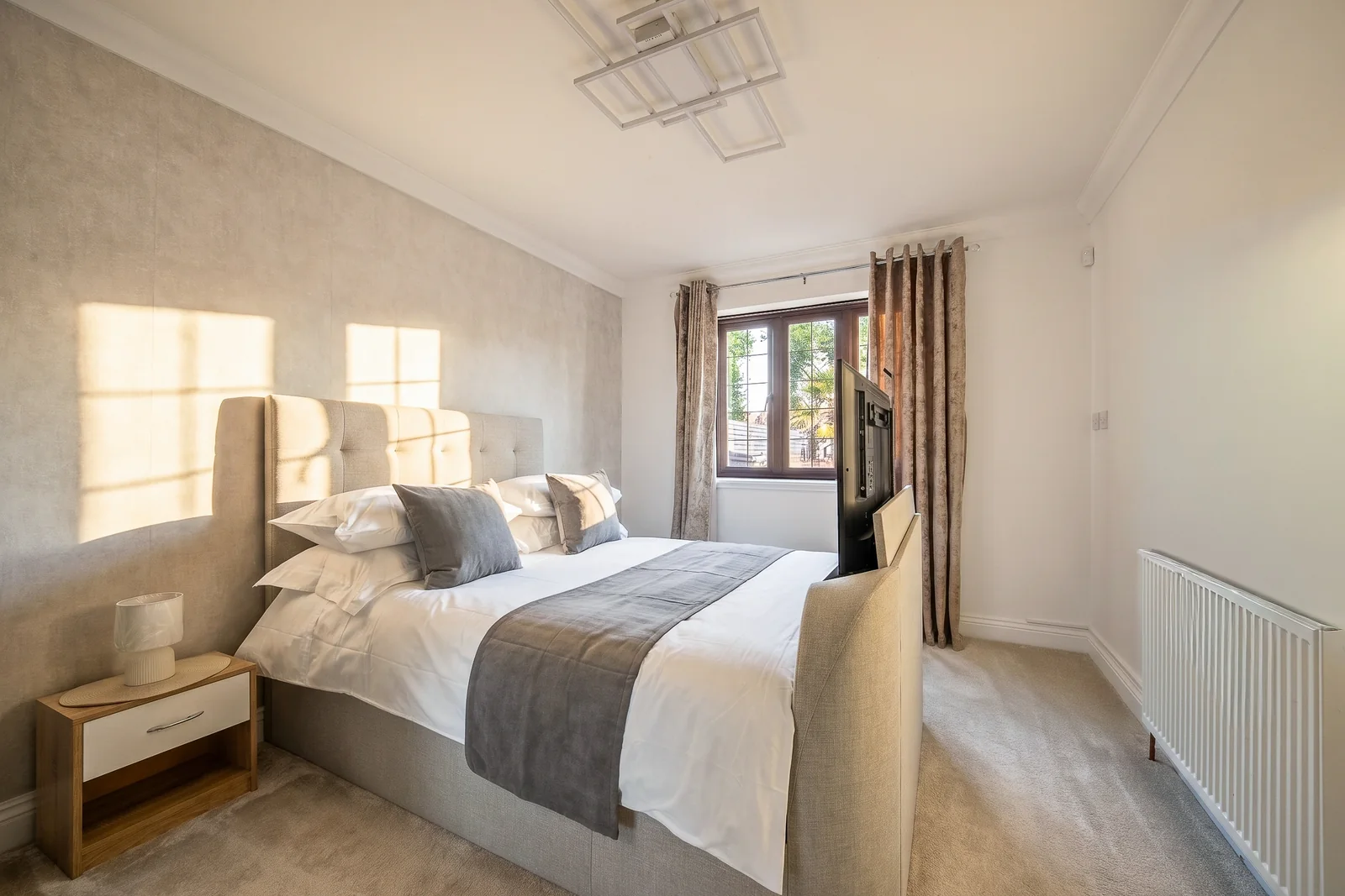 Stylised sunlit bedroom photographed for property marketing